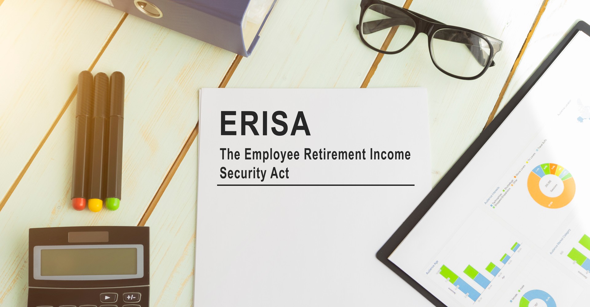 Paper with ERISA employee retirement income law on the table